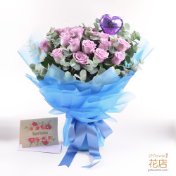 A bouquet of lavender roses and eucalyptus leaves featuring a custom-printed clear balloon in the center.